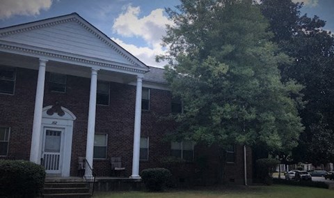A building with a white door and pillars.