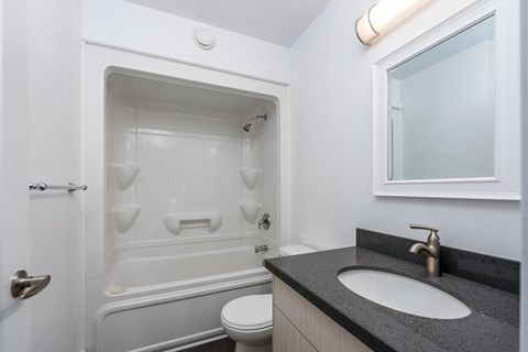 a bathroom with a shower and a sink and a mirror