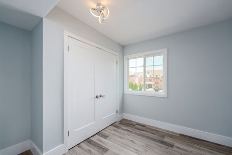 a bedroom with a door and a window
