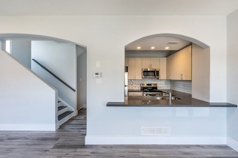 a kitchen with a counter top and a staircase