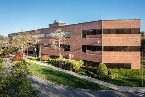 A modern building with a curved facade and large windows.