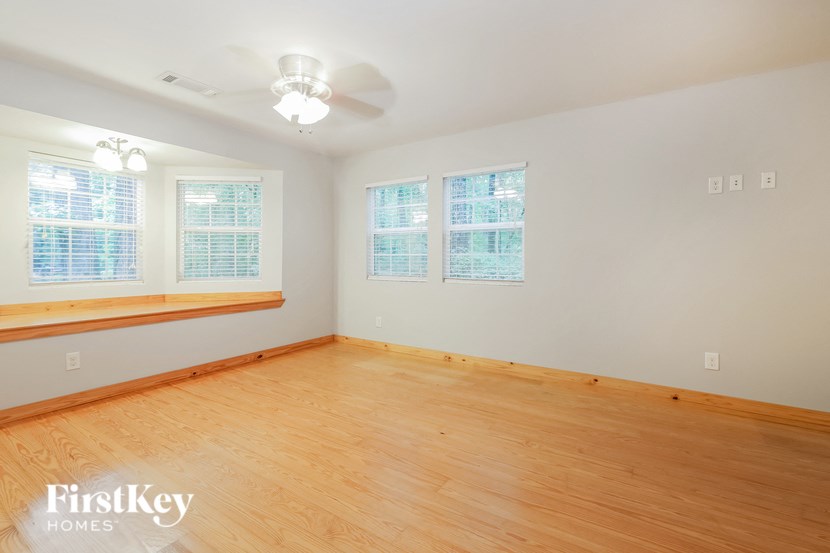 a living room with a wood floor and a ceiling fan