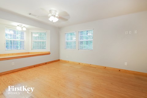a living room with a wood floor and a ceiling fan