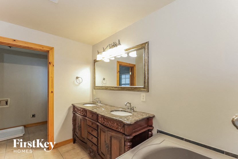 a bathroom with a sink and a tub and a mirror