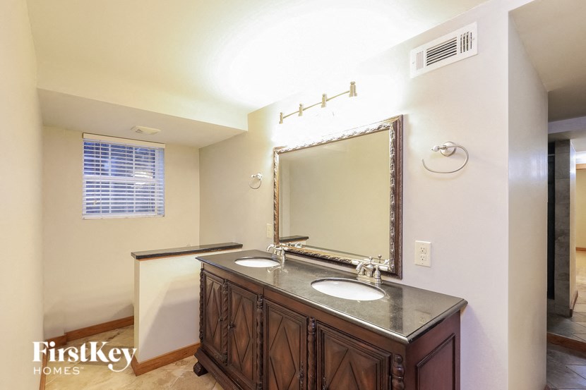 a bathroom with two sinks and a large mirror
