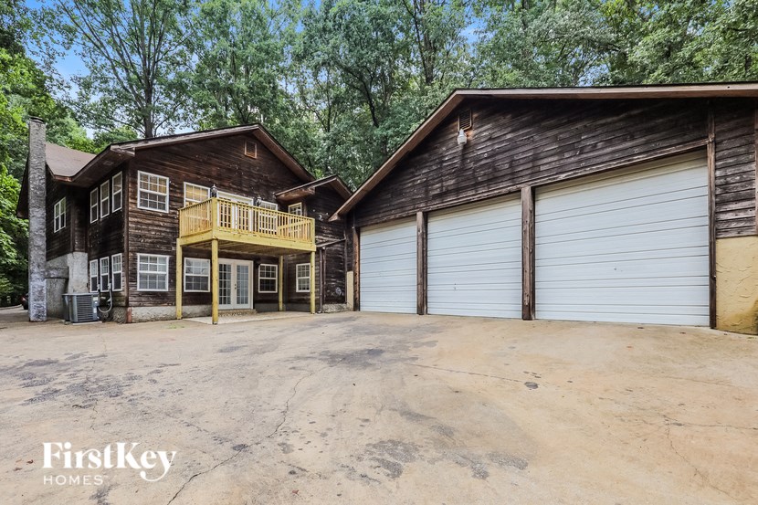 a garage and a house with two garages and a driveway