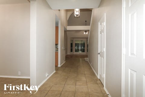 A long hallway with a FirstKey Homes logo on the bottom left.