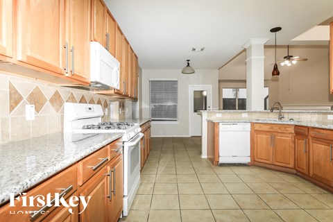 A kitchen with wooden cabinets and a white oven.
