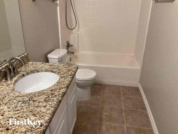 a bathroom with a sink and a toilet and a shower