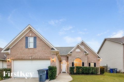A brick house with a garage and a driveway.