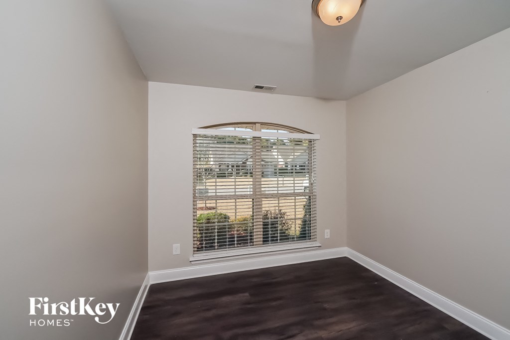 the living room of an empty house with a large window