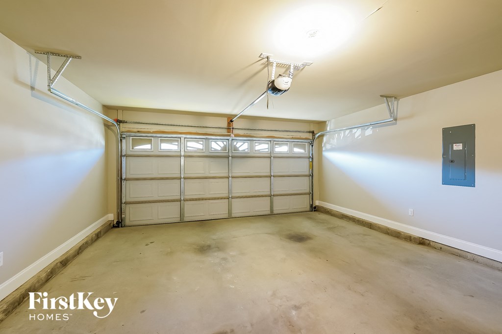 a garage with white walls and a blue door