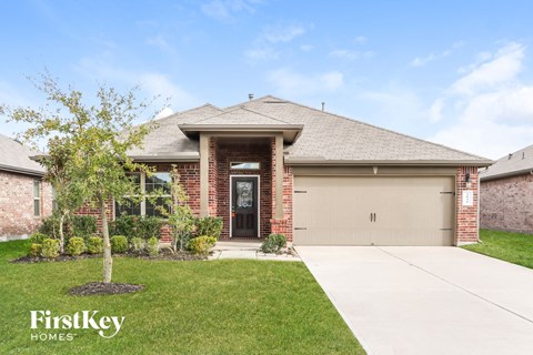 front view of a brick house with a garage door