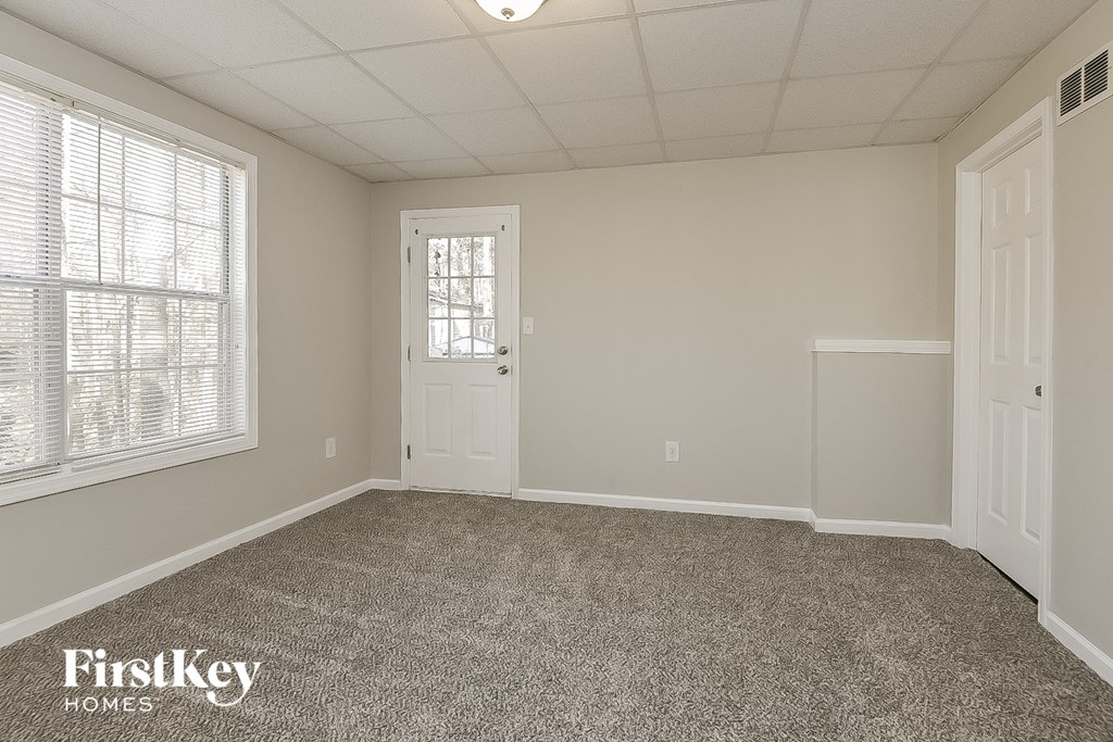 a bedroom with a carpeted floor and a white door
