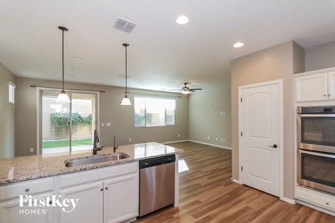 a kitchen with white cabinets and a sink and a counter top
