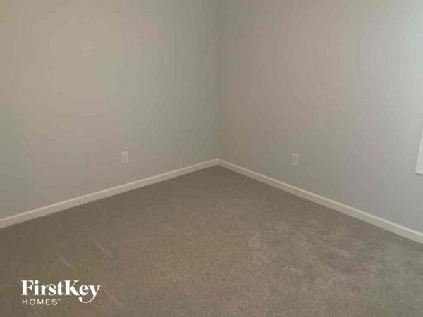 A room with a FirstKey Homes logo on the wall.