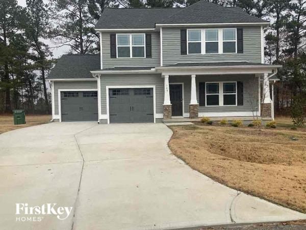 A two-story house with a garage is for sale.