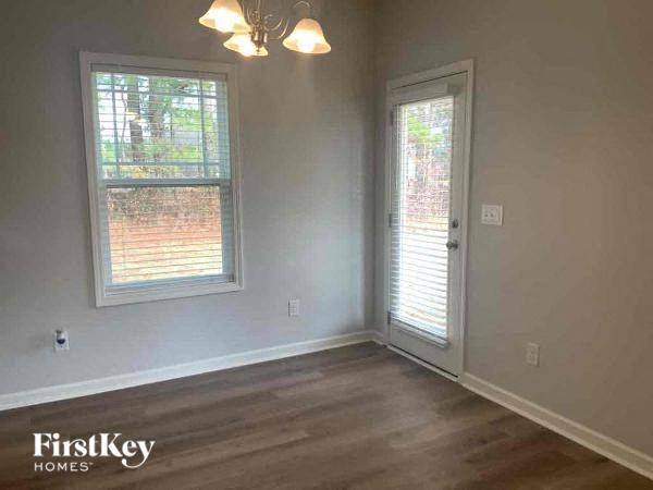 A room with a window and a door is available for rent.
