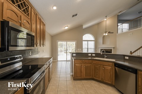 A kitchen with wooden cabinets and stainless steel appliances.