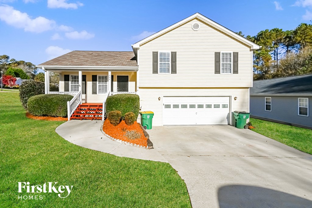 A house with a garage and a driveway in front of it.
