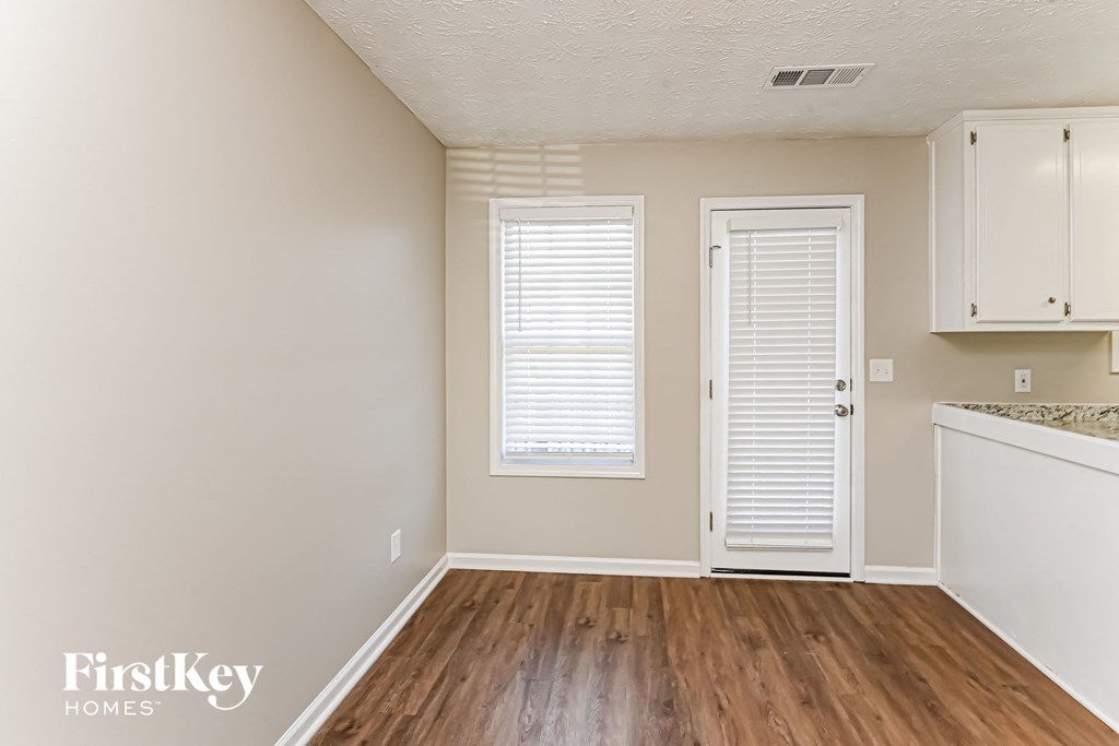 A room with wooden floors and white walls.