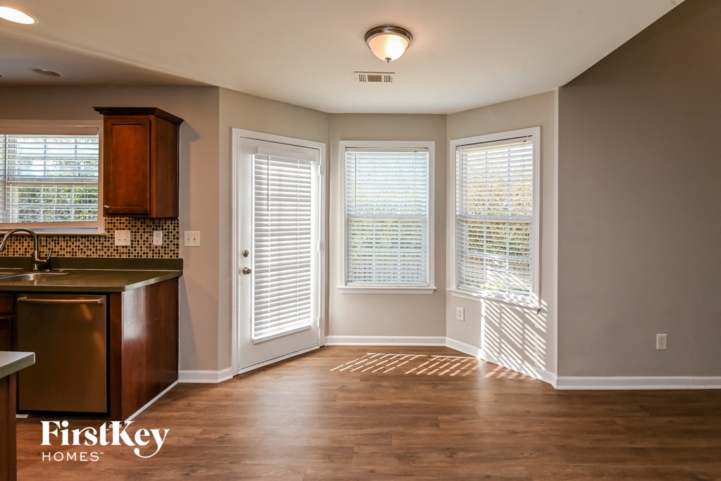 an empty kitchen with a sink and windows