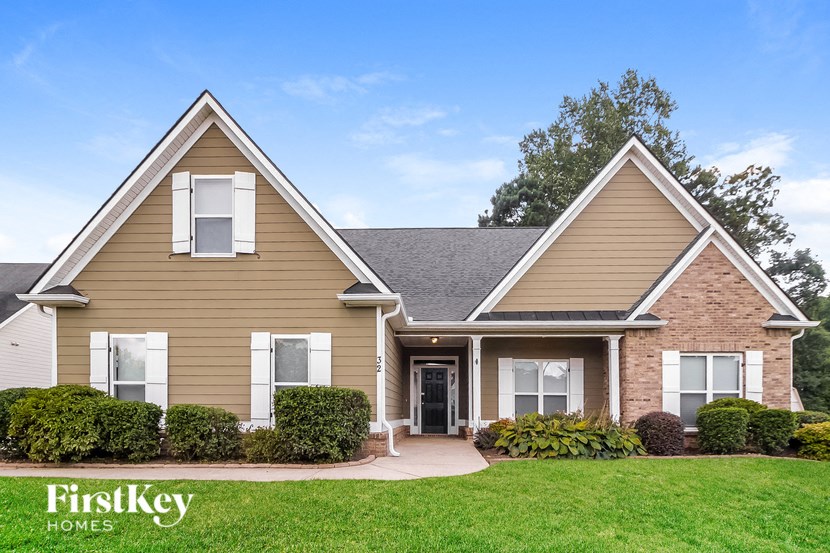 a house with a green lawn and a blue sky