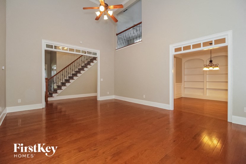 a living room with a hard wood floor and a staircase