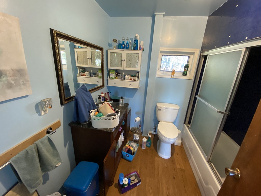 a bathroom with a toilet and a sink and a shower