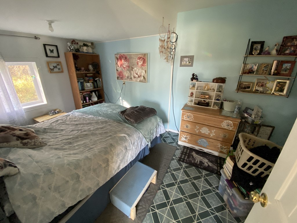 a bedroom with a bed and a dresser