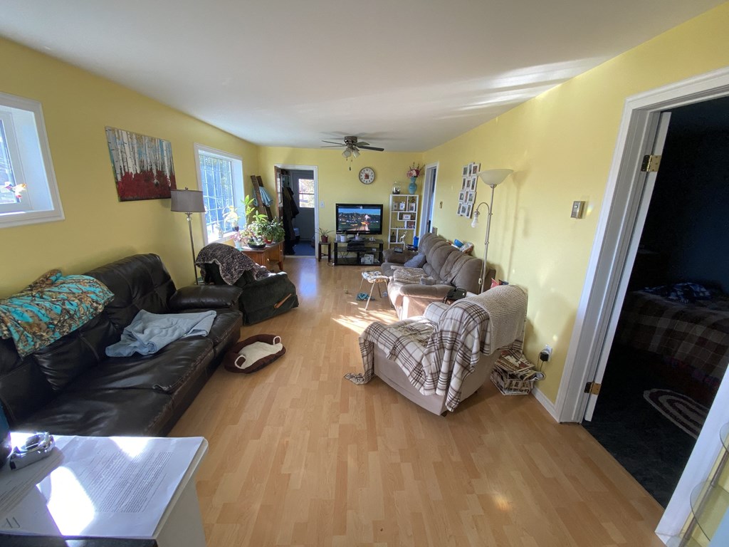 a living room with yellow walls and a wood floor