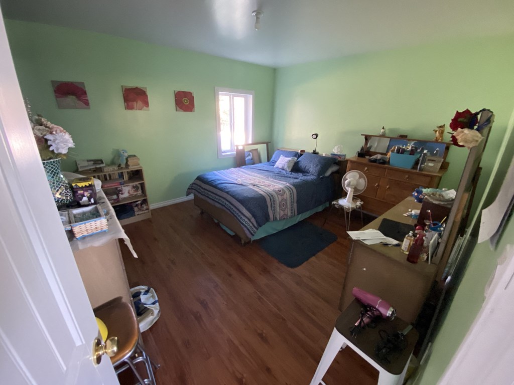 a bedroom with a bed and a dresser and a closet