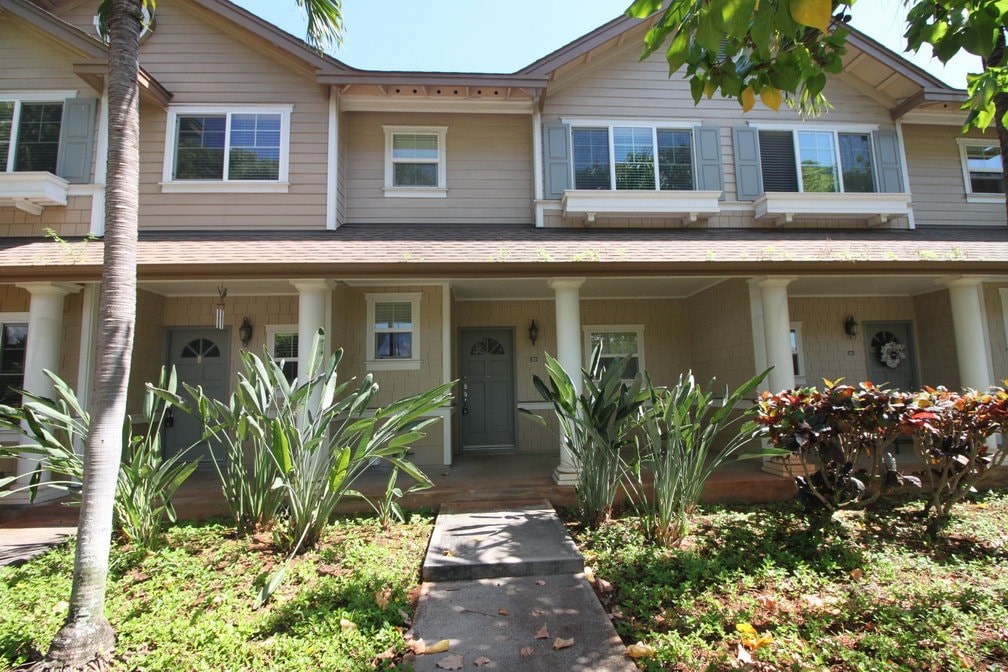 A building with a brown roof and white columns.