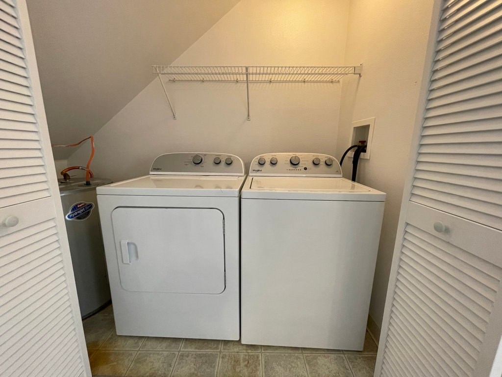 A white dryer and washer in a small laundry room.