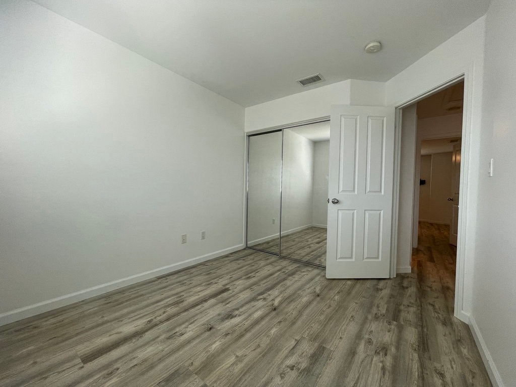 A room with a white door and a white wall.