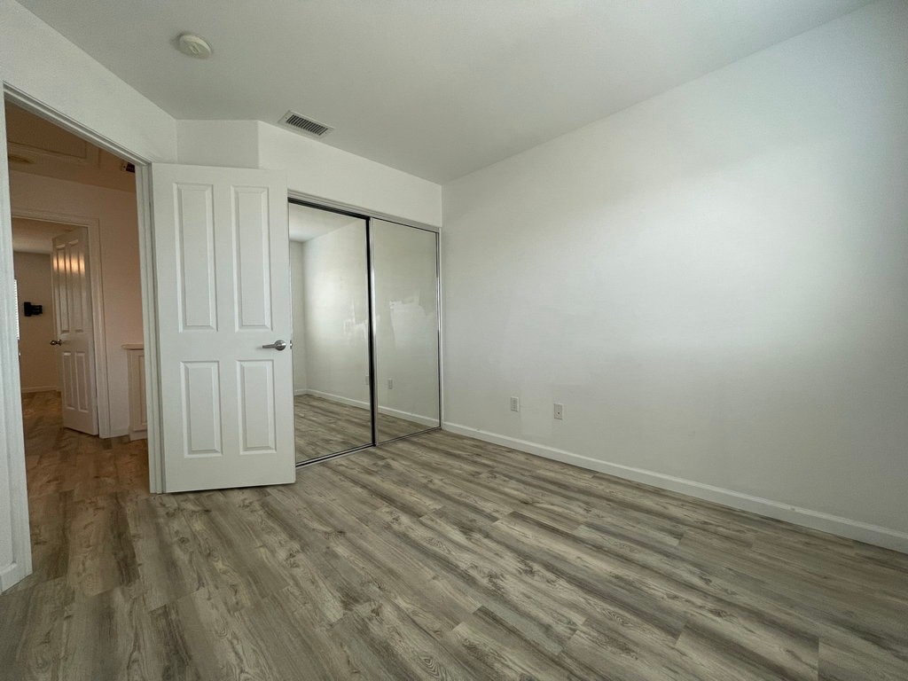 A room with a white door and a sliding glass door.