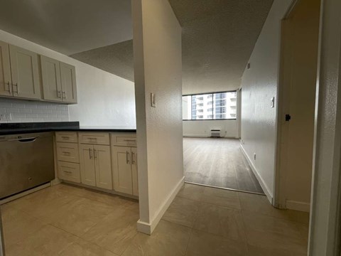 A kitchen with beige cabinets and a tiled backsplash.