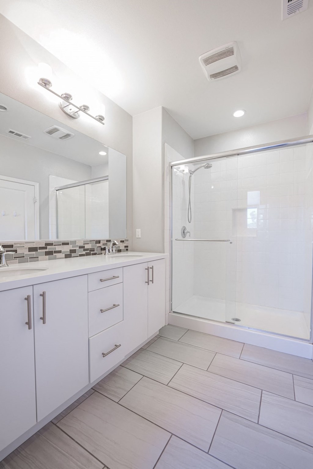 a bathroom with a shower and a sink and a mirror