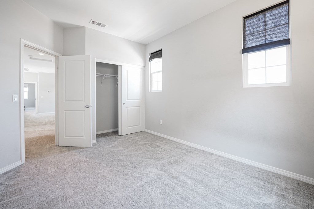 an empty living room with white walls and white door and window