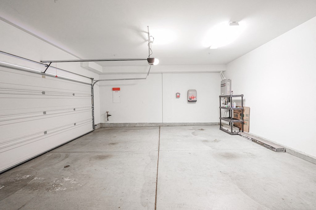 the interior of a garage with white walls and a white garage door