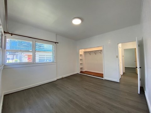 A spacious room with a grey floor and white walls.