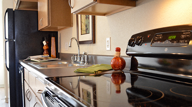 a kitchen with a sink and a stove and a microwave