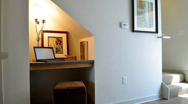 a laptop computer sitting on a desk in a living room