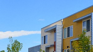 a view of the exterior of a building with trees and grass