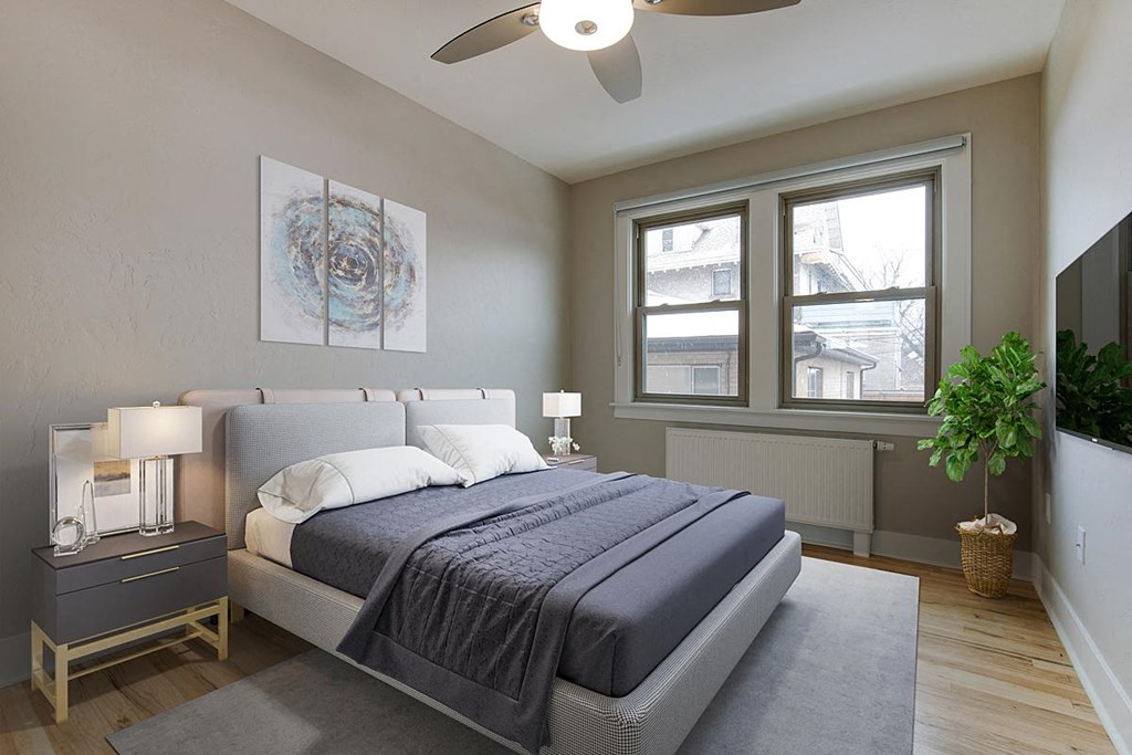 a bedroom with a bed and a ceiling fan