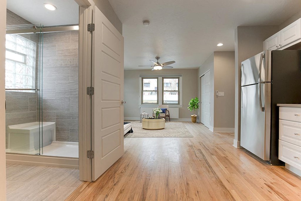 a large bathroom with a shower and a sink
