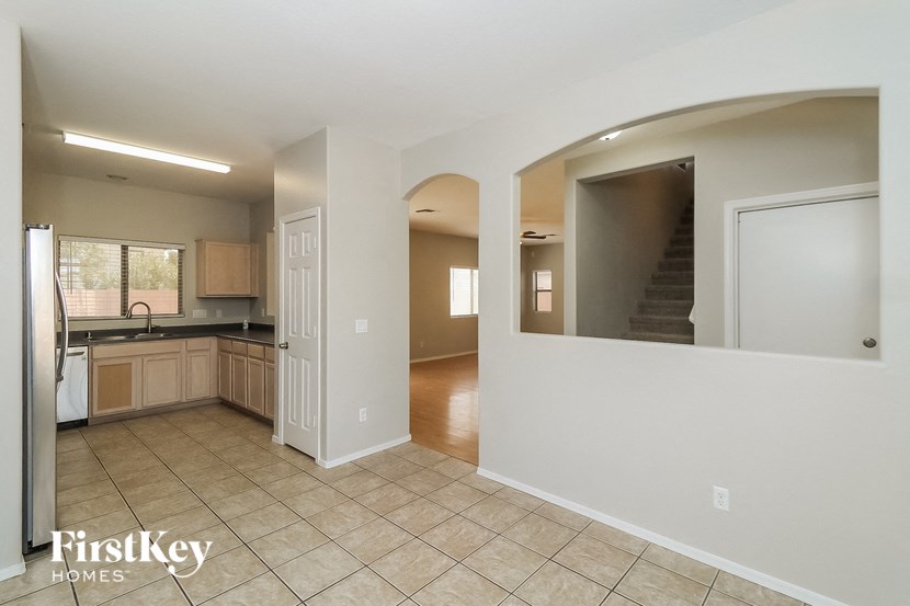an empty kitchen with a door to the living room