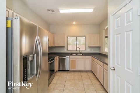 a kitchen with a stainless steel refrigerator and a sink