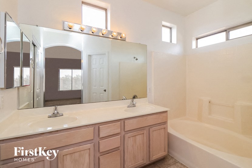 a bathroom with a sink and a mirror and a tub