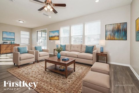 A living room with a couch, chairs, and a coffee table.